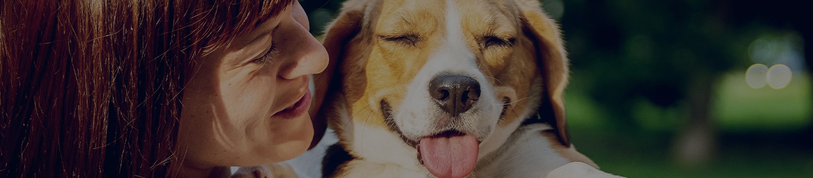 woman holding happy dog